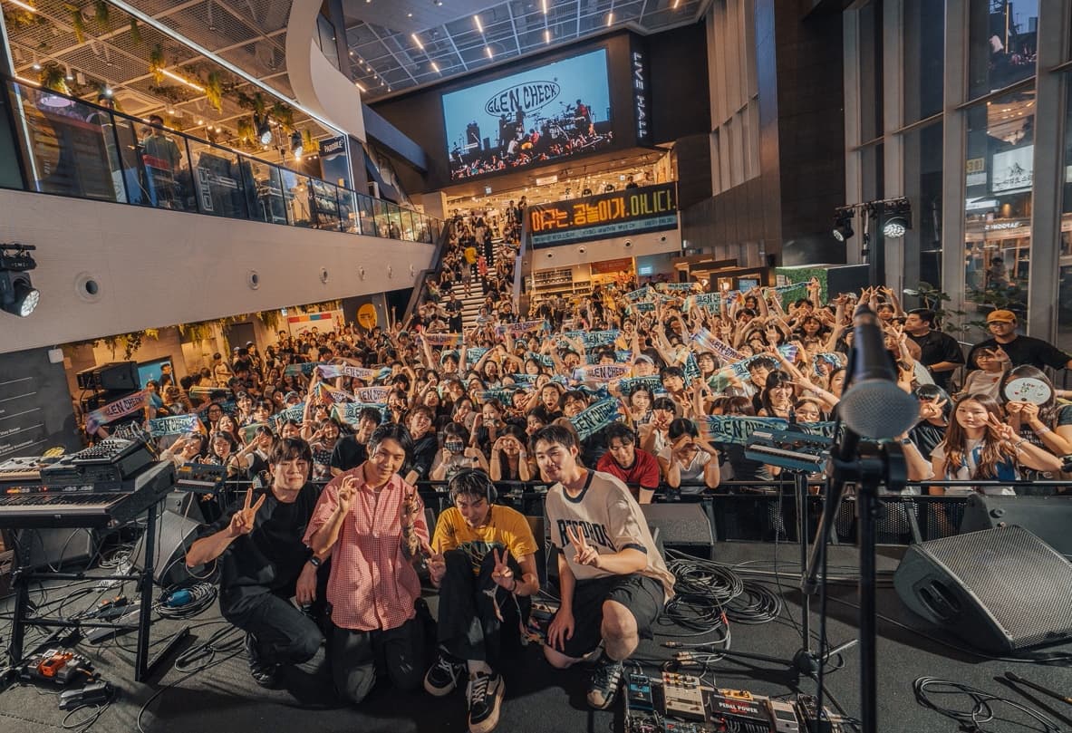 Members of the bands that participated in the festival are seen taking photographs with the audience