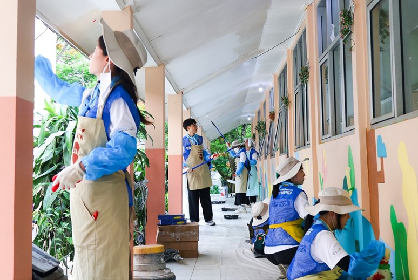 The photo shows members drawing murals as part of their volunteering activity in Indonesia on January 10.