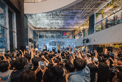 Members of the bands that participated in the festival are seen taking photographs with the audience after their performance.